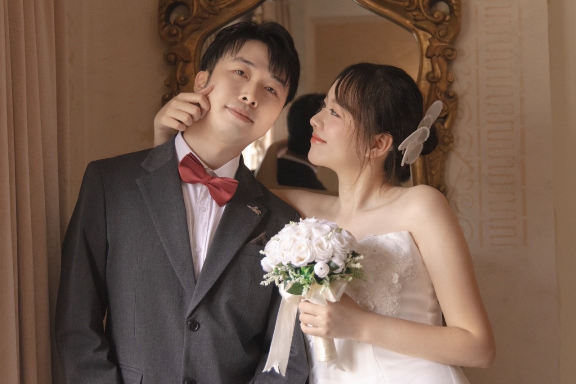 A portrait of the couple by the mirror